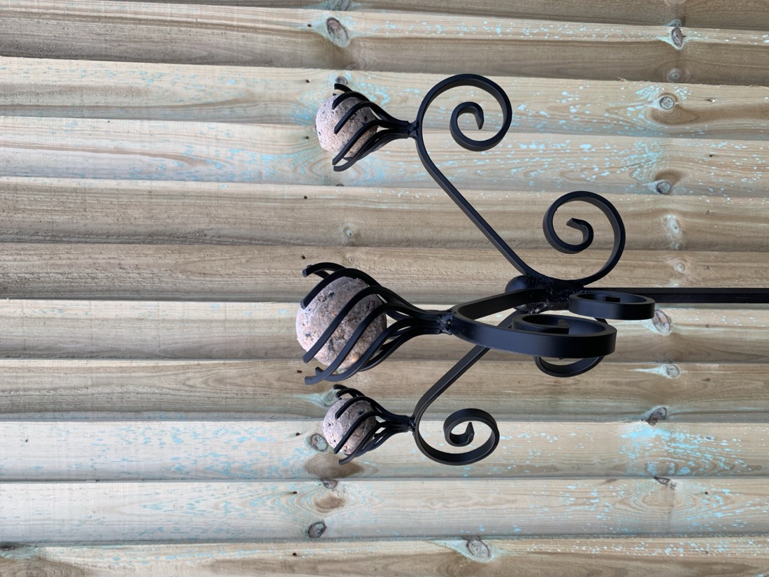 Steel bird feeder in the garden